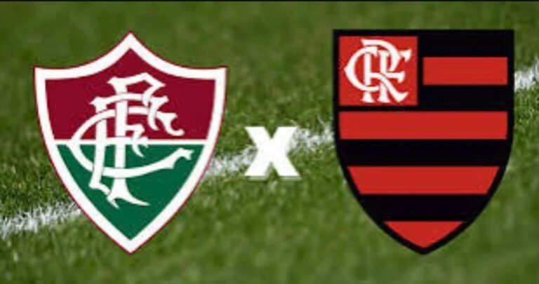 Escudos dos clubes Fluminense e Flamengo posicionados lado a lado sobre um gramado de futebol, simbolizando a preparação para mais um clássico.